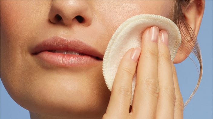 woman cleaning face